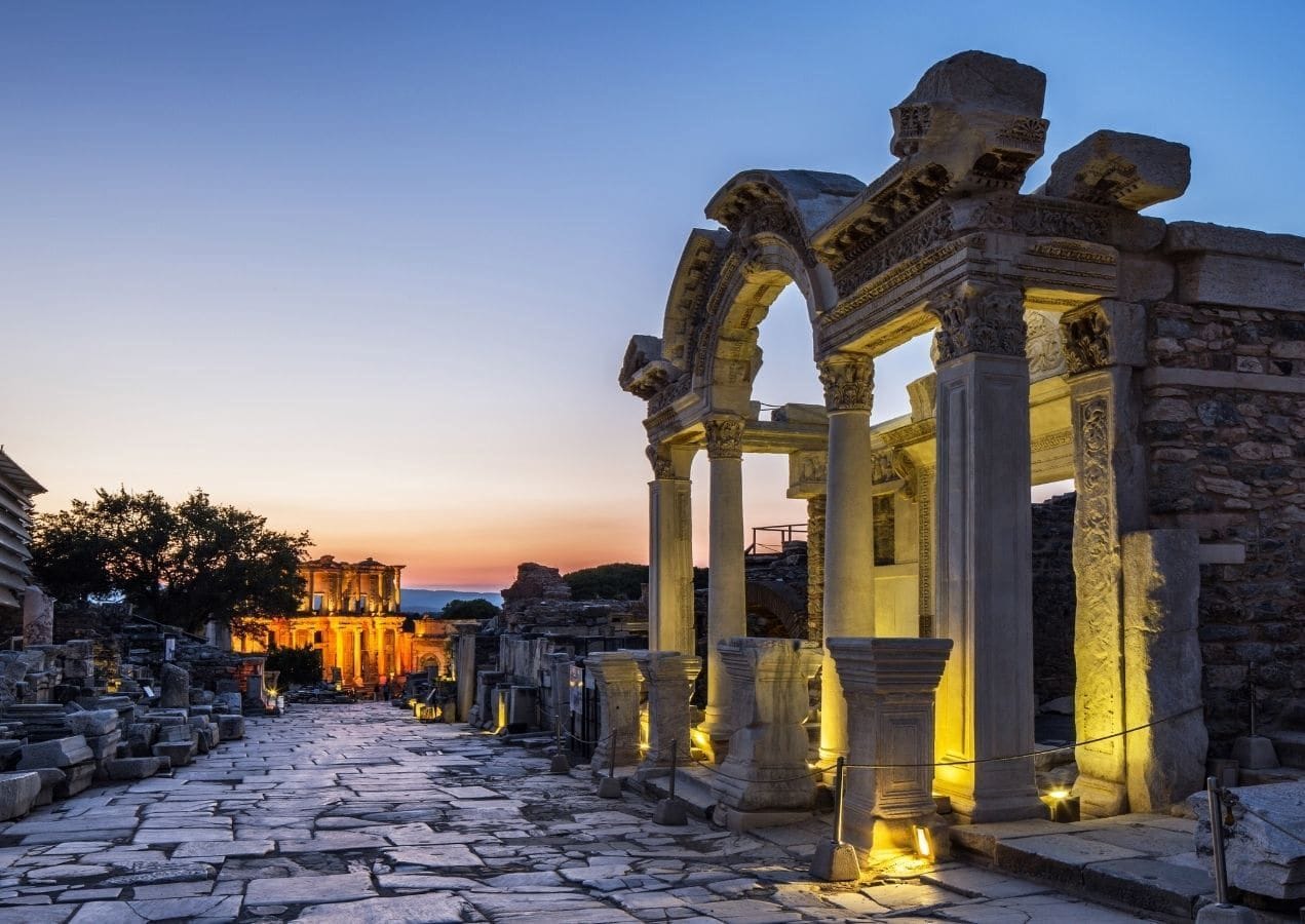 Ancient columns and arches of Ephesus lit at sunset